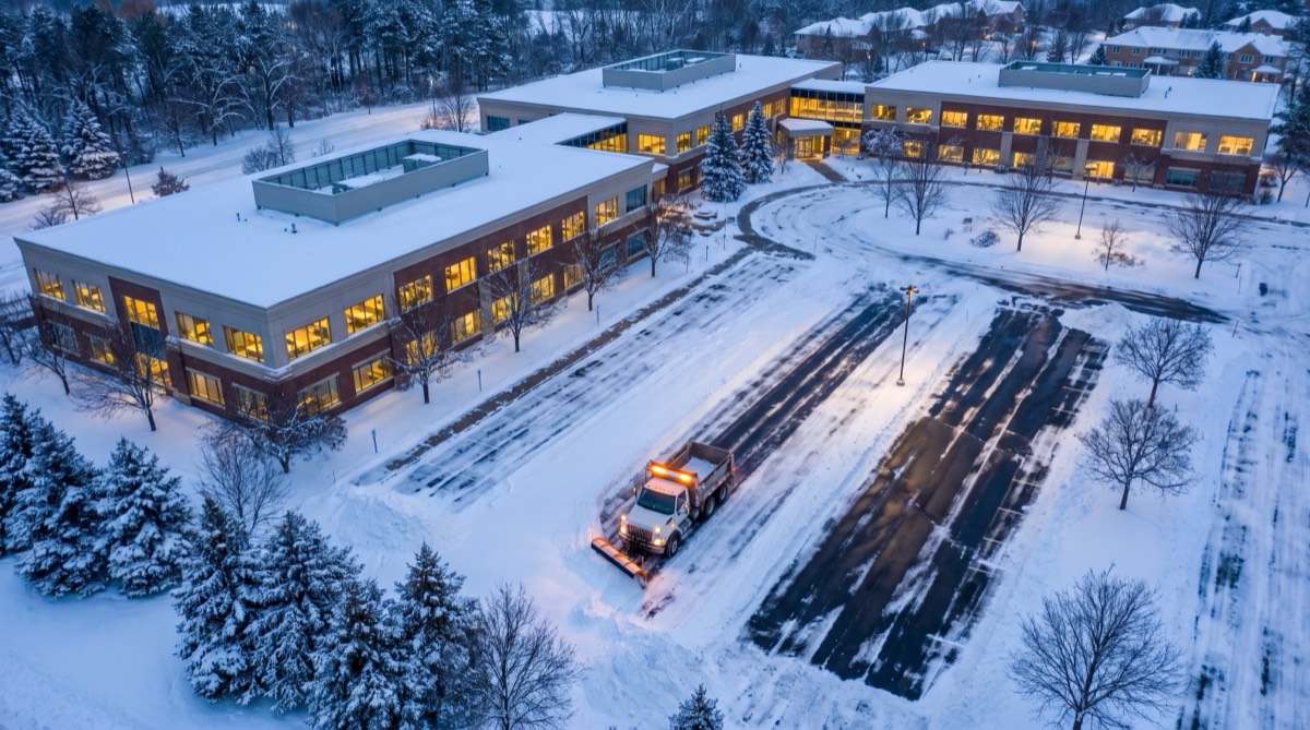 Commercial snow removal — plowed office campus at dawn